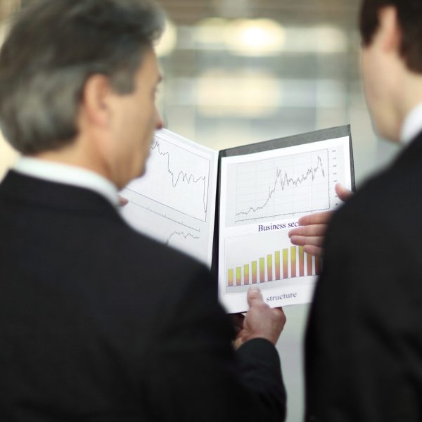 rear view.closeup of business partners discussing financial documents